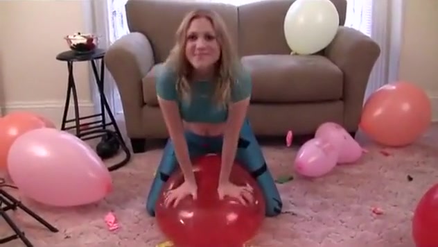 Girl popping balloons