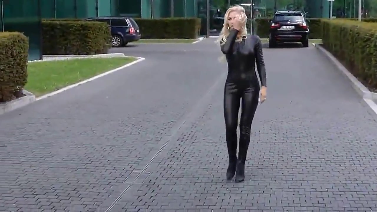 Sexy blonde lady black leather catsuit