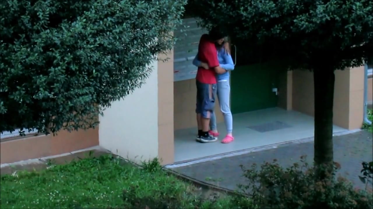 Beautiful college girl college girl  couple kissing cuddling and caressing outside