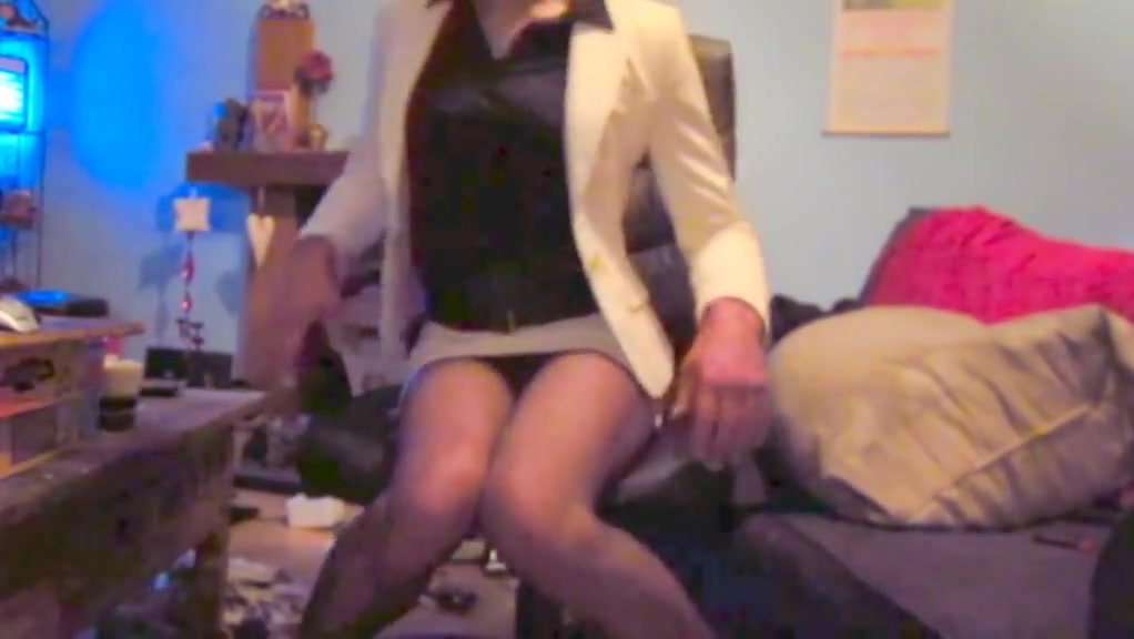 Wearing a white mini skirt suit  stockings   high heels