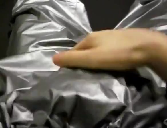 Guy wearing  a silver sauna suit with plastic pants